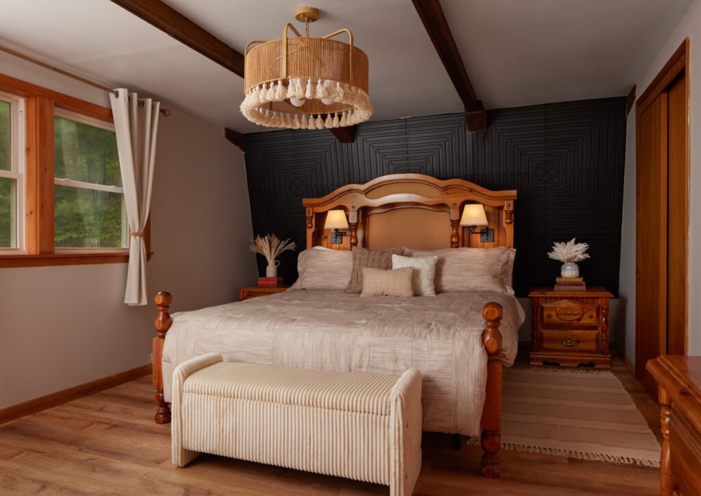 Primary bedroom at the Adirondack cabin with lights on, the kind of lighting variable AI photo editing can fix