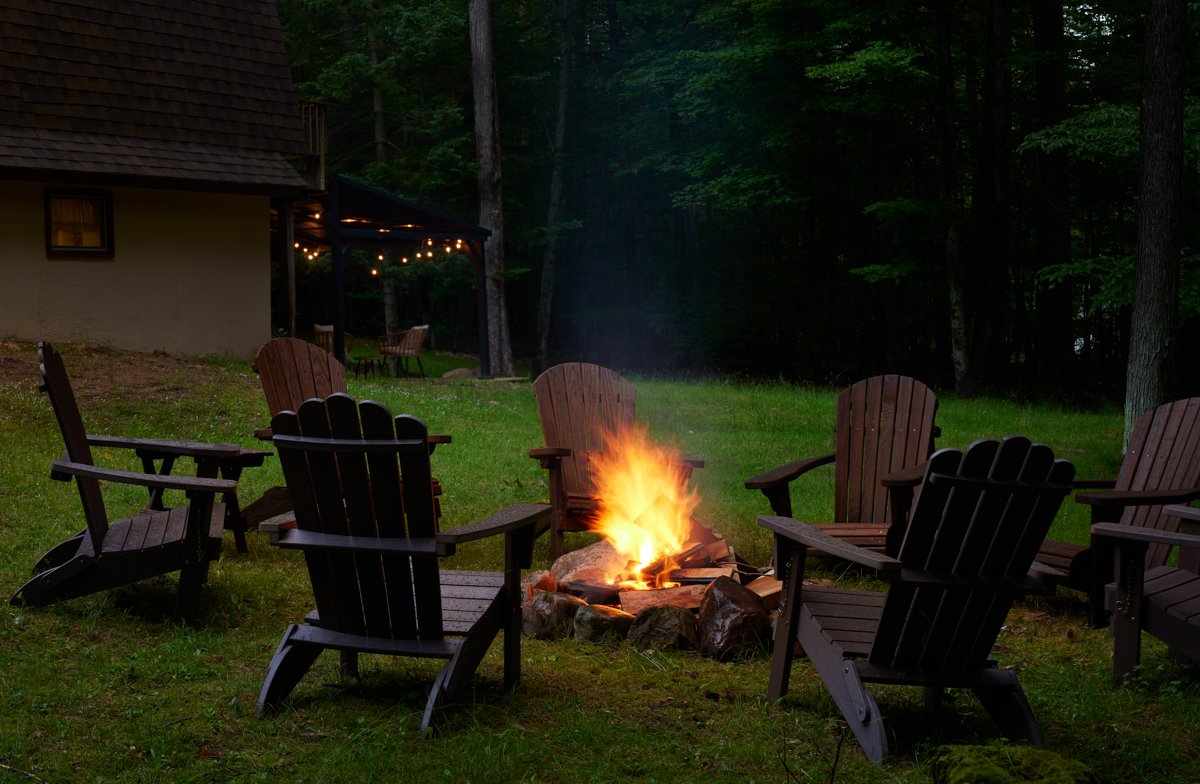 Fire pit at the Jay, NY Adirondack cabin, the seasonal outdoor space that predates any AI tool in the hosting operation