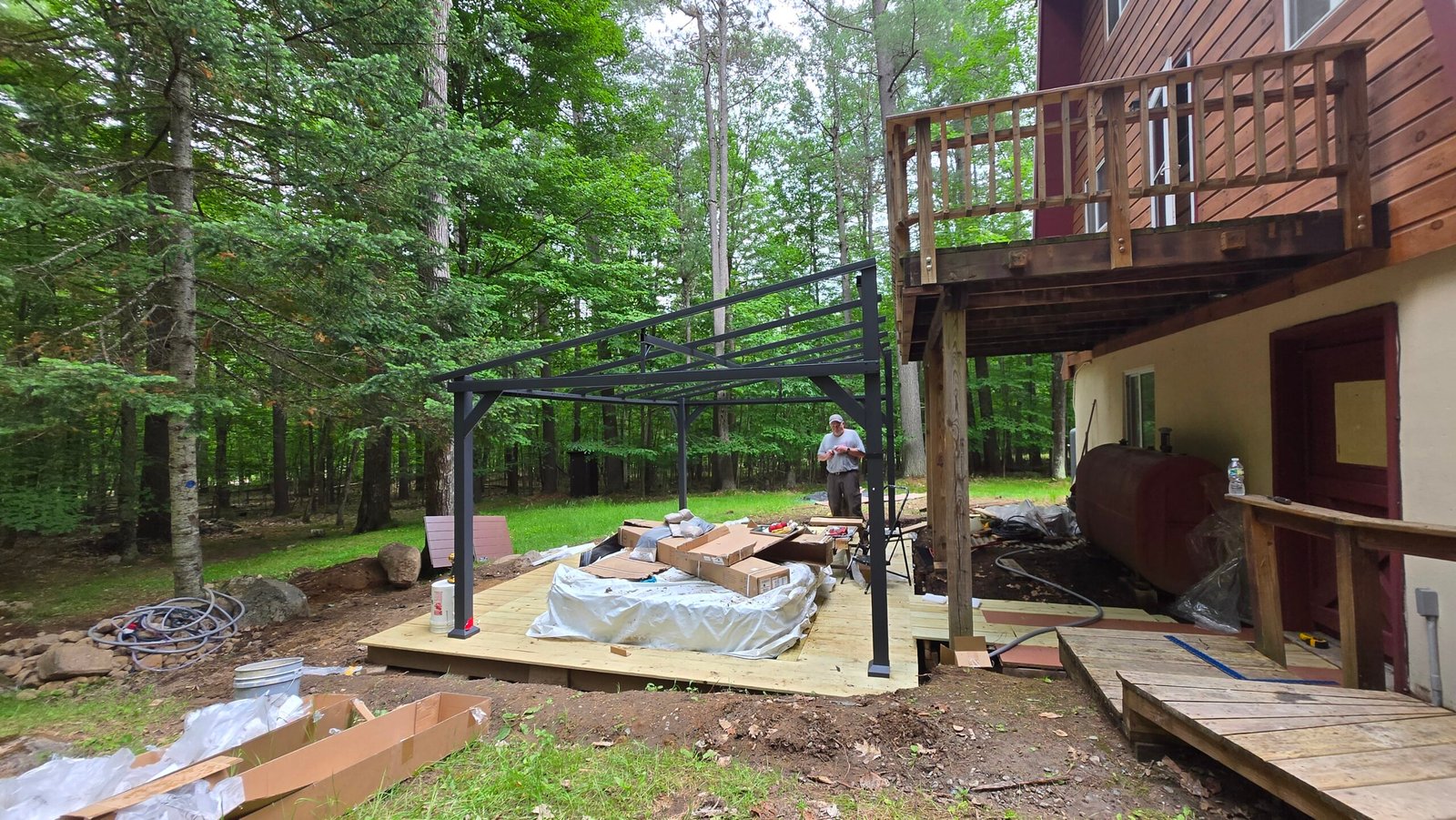 Byunghun assembling a pergola structure at the Adirondack cabin