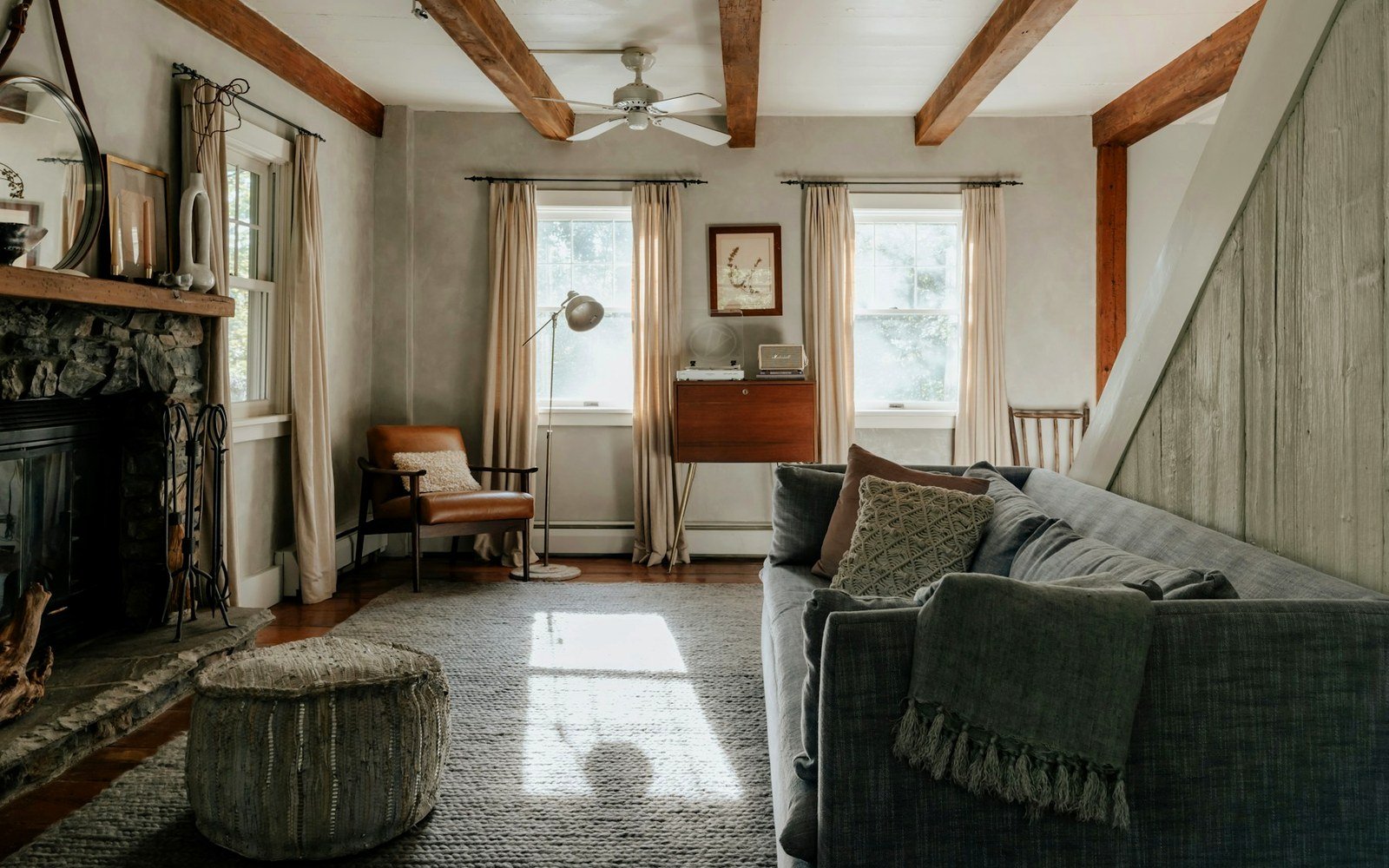 Cozy Adirondack cabin seating area with wool blanket and warm lamp light