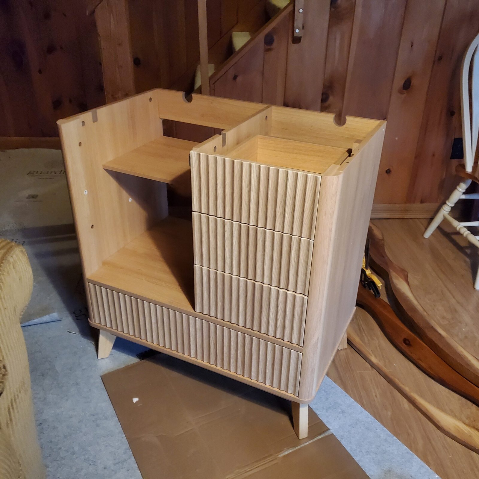 New reeded-front vanity cabinet being assembled for the Jay bathroom while demo wrapped up